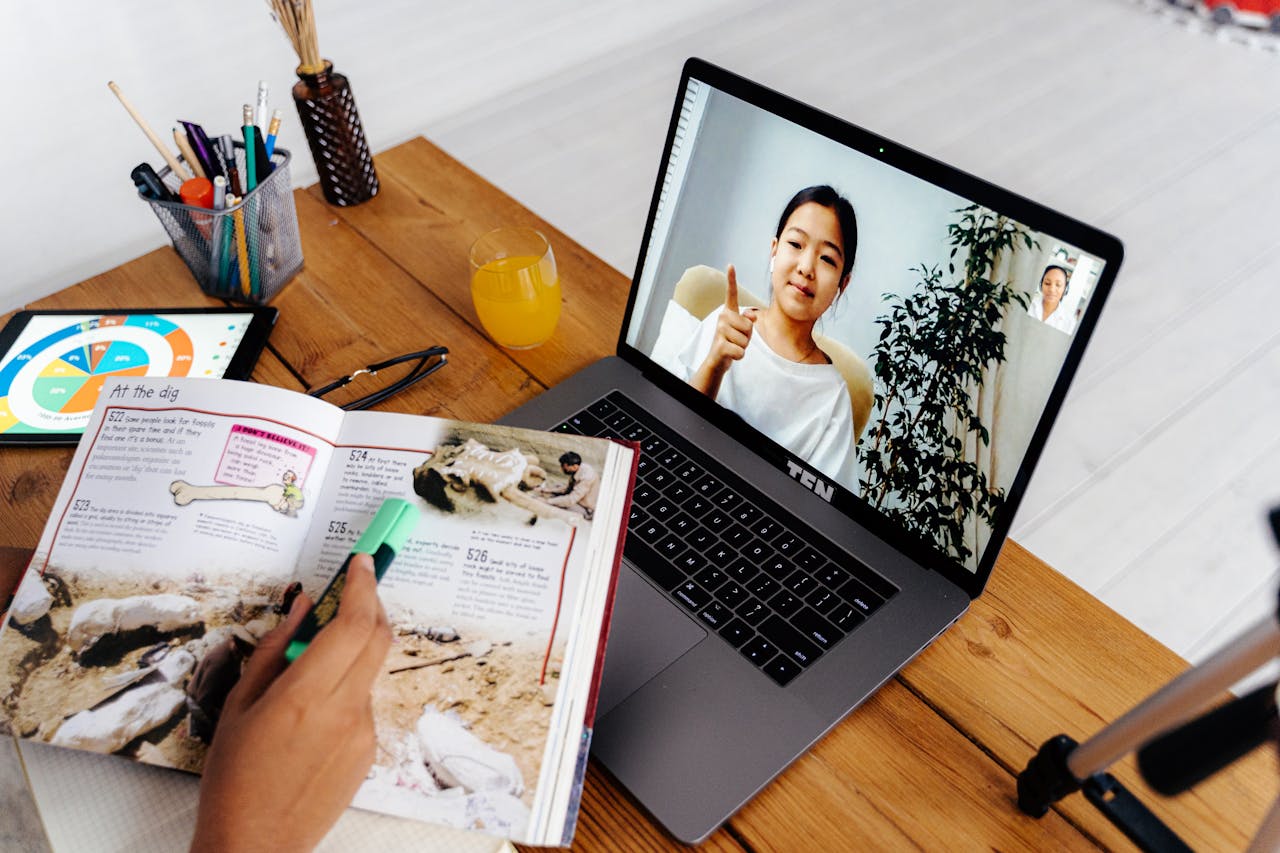 heros-img Online teaching session with digital tools, featuring a woman on a laptop screen and educational materials.